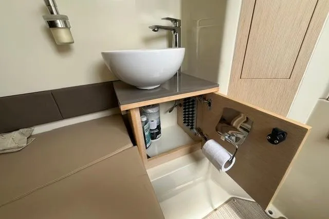 Slide: The Image of 2024 Chris-Craft Catalina 30 bathroom interior with modern sink and storage cabinet. - 23