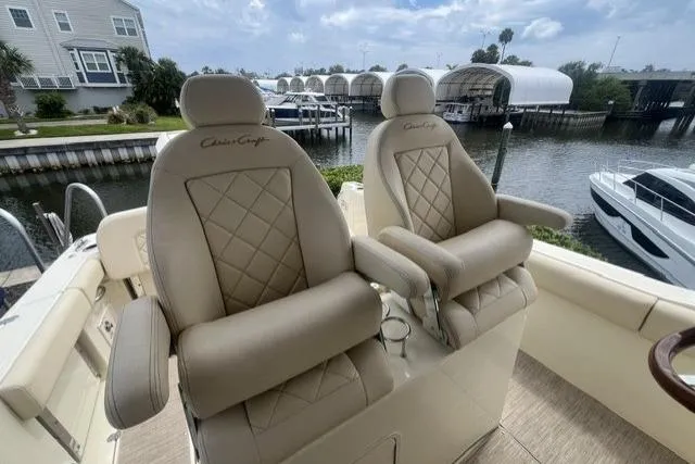 Slide: The Image of Luxurious 2024 Chris-Craft Catalina 30 boat seats with diamond stitching, docked near waterfront homes. - 25