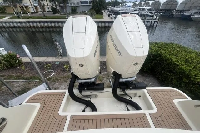 Slide: The Image of 2024 Chris-Craft Catalina 30 with dual Mercury outboard engines docked by a marina. - 30