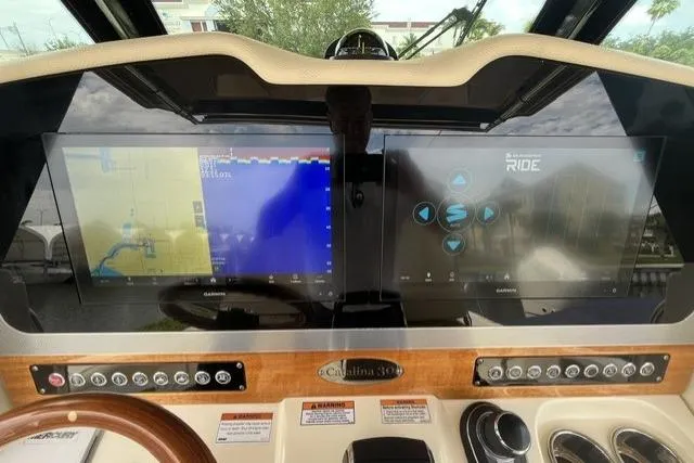 Slide: The Image of 2024 Chris-Craft Catalina 30 helm with dual Garmin displays and advanced navigation controls. - 31