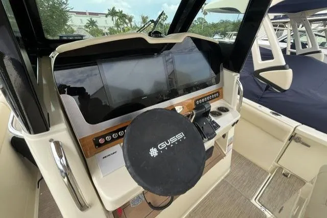 Slide: The Image of 2024 Chris-Craft Catalina 30 helm with modern controls and Gussi steering wheel cover. - 8