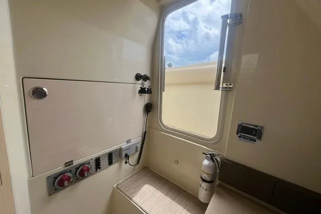 Slide: The Image of 2024 Chris-Craft Catalina 30 interior with control panel and window view. - 9