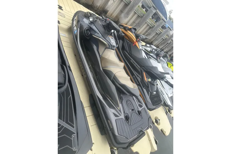 Slide: The Image of 2022 Sea-Doo GTX Limited 300 jet ski docked alongside other watercraft. - 3
