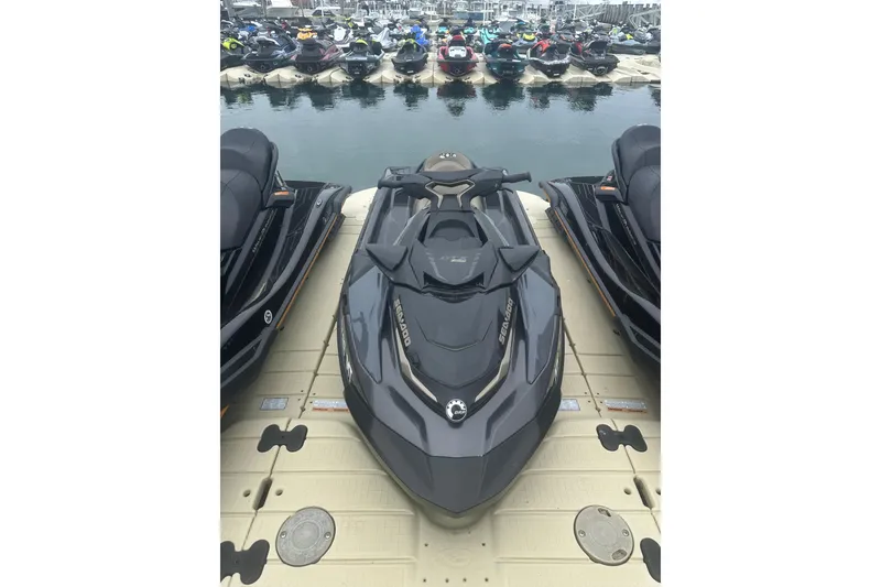 Slide: The Image of 2022 Sea-Doo GTX Limited 300 jet ski docked at marina, surrounded by other watercraft. - 5