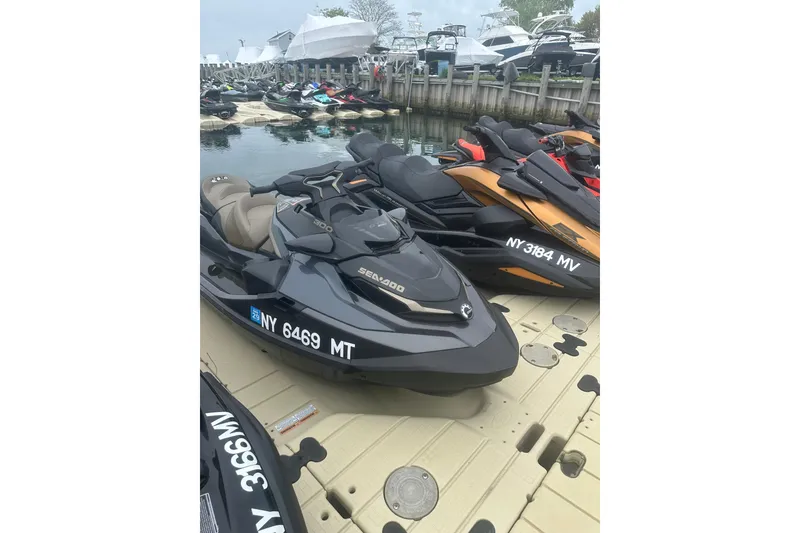 Slide: The Image of 2022 Sea-Doo GTX Limited 300 jet ski docked at marina with other watercraft. - 6