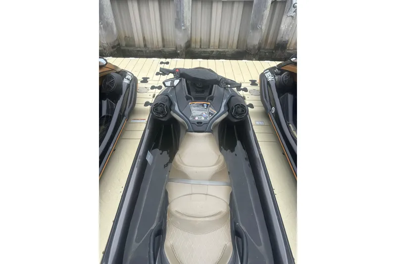 Slide: The Image of 2022 Sea-Doo GTX Limited 300 jet ski docked, showcasing sleek design and beige seating. - 7