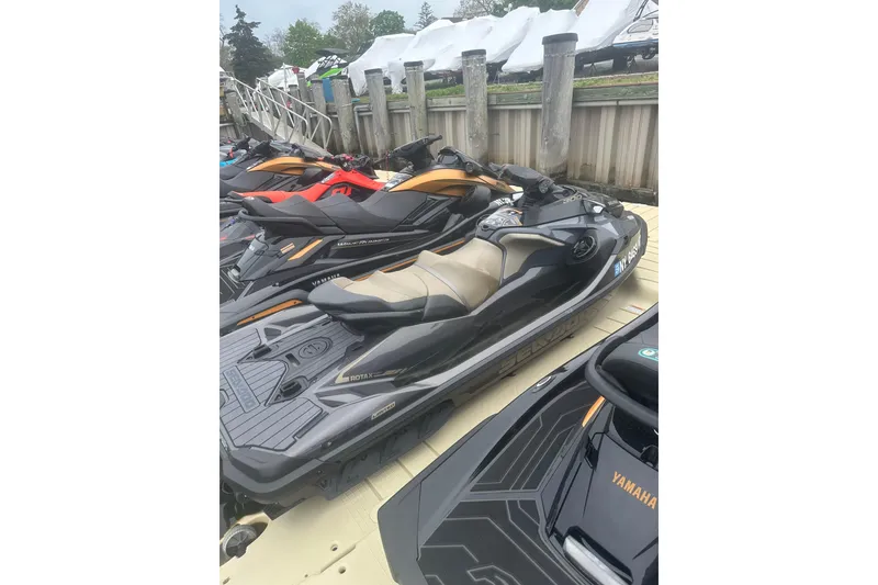 Slide: The Image of 2022 Sea-Doo GTX Limited 300 jet ski docked alongside other watercraft. - 8