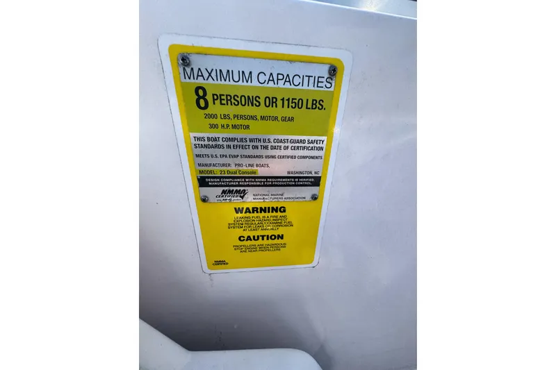 Slide: The Image of PROLINE 23DC 2016 boat capacity label, maximum 8 persons or 1150 lbs, 300 HP motor. - 11