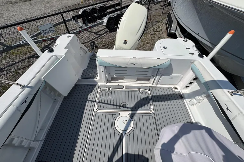 Slide: The Image of 2016 PROLINE 23DC boat deck with seating and storage compartments. - 13