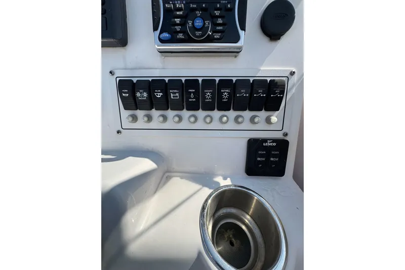 Slide: The Image of Control panel of a 2016 PROLINE 23DC boat with switches and cup holder. - 9