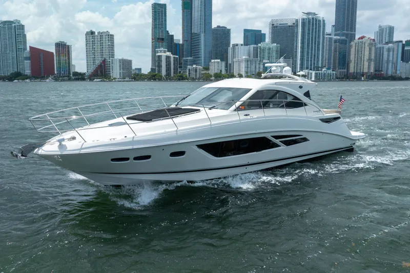 The Image of 2017 Sea Ray Sundancer 510 yacht cruising near city skyline. - 0