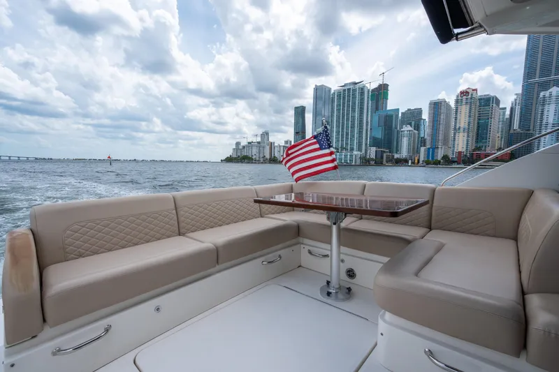 Slide: The Image of Luxurious 2017 Sea Ray Sundancer 510 yacht with city skyline and American flag. - 12