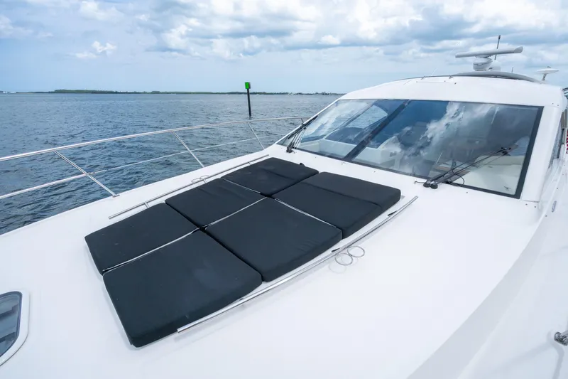Slide: The Image of 2017 Sea Ray Sundancer 510 yacht with sun pads on deck, cruising on open water. - 16