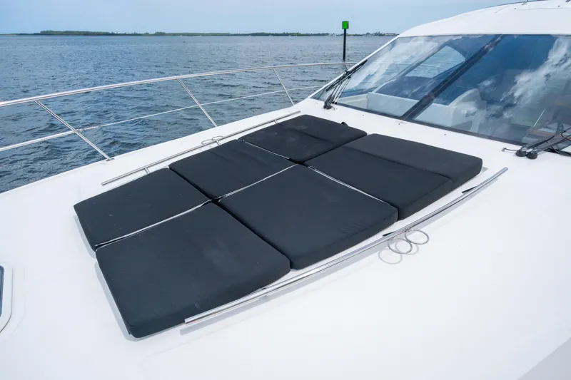 Slide: The Image of 2017 Sea Ray Sundancer 510 yacht with sun pads on deck, ocean view. - 17