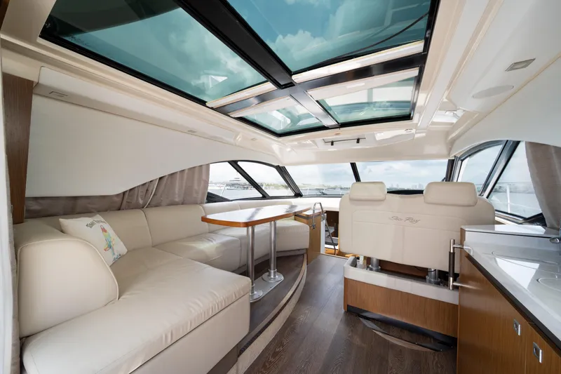 Slide: The Image of Luxurious interior of 2017 Sea Ray Sundancer 510 yacht with panoramic windows and plush seating. - 18