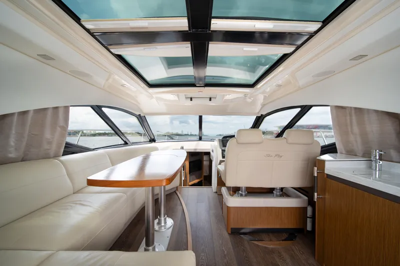 Slide: The Image of Luxurious interior of 2017 Sea Ray Sundancer 510 yacht with panoramic windows and elegant seating. - 19