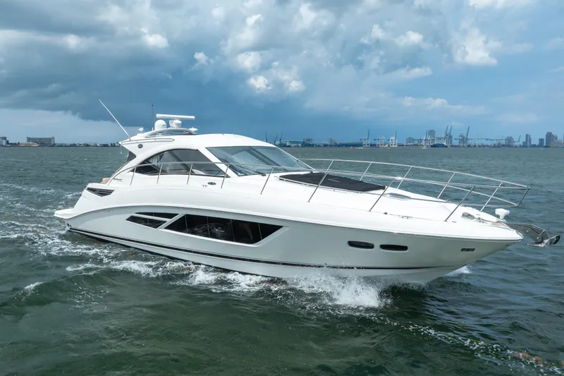 Slide: The Image of 2017 Sea Ray Sundancer 510 yacht cruising on open water under cloudy skies. - 2