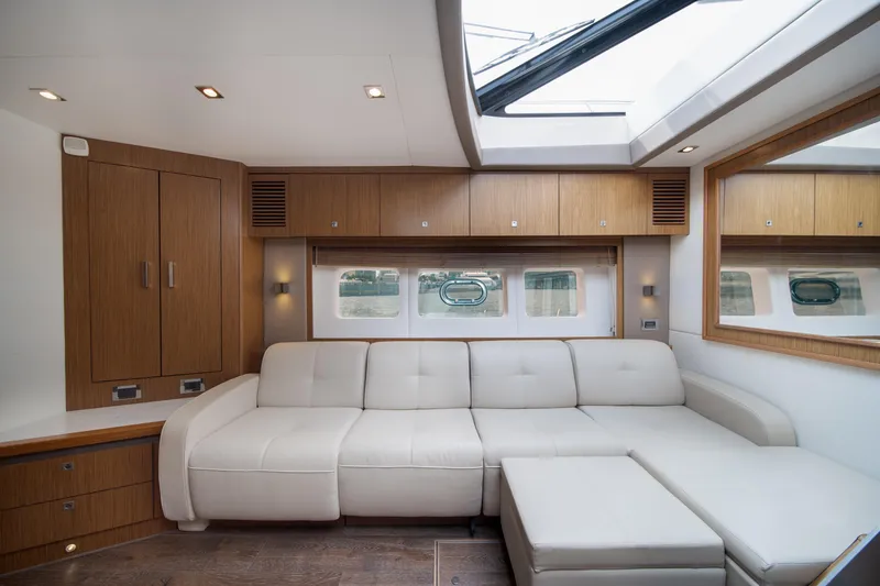 Slide: The Image of Luxurious interior of 2017 Sea Ray Sundancer 510 yacht with elegant white seating and wood accents. - 28