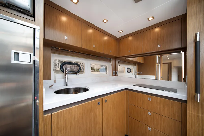 Slide: The Image of Luxurious 2017 Sea Ray Sundancer 510 yacht kitchen with modern wood cabinetry and sleek countertops. - 31