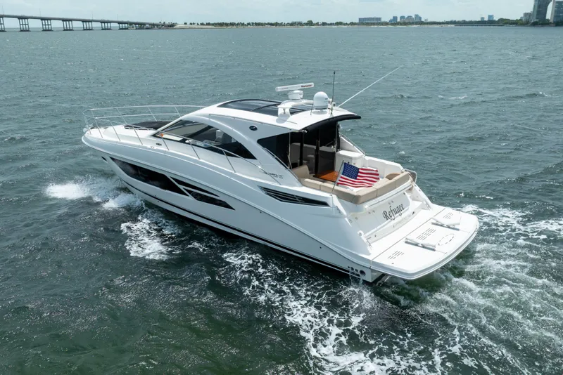 Slide: The Image of 2017 Sea Ray Sundancer 510 yacht cruising on open water with American flag displayed. - 5