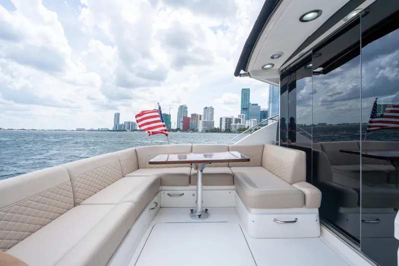 Slide: The Image of Luxurious 2017 Sea Ray Sundancer 510 yacht with city skyline and American flag. - 8
