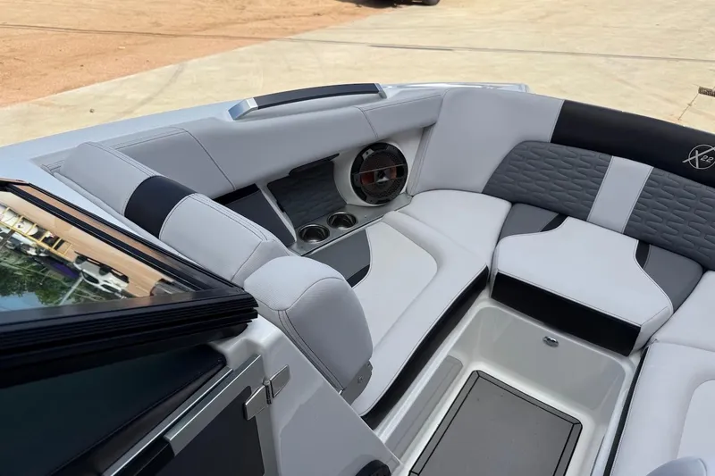Slide: The Image of 2019 MasterCraft X22 boat interior with sleek seating and built-in speaker system. - 10
