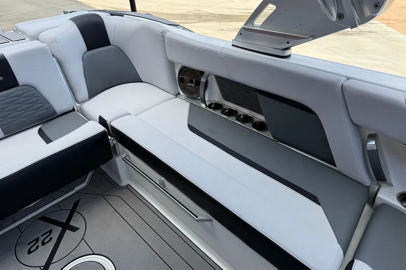Slide: The Image of 2019 MasterCraft X22 boat interior with sleek seating and cup holders. - 17