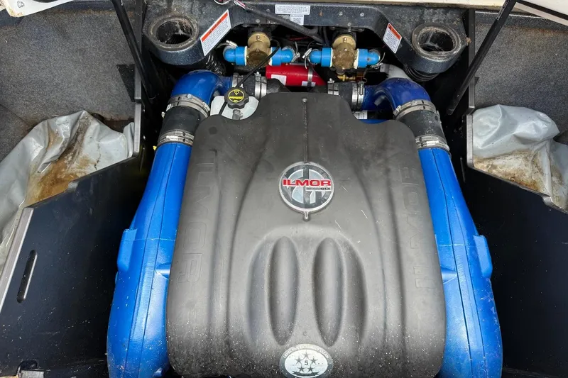 Slide: The Image of 2019 MasterCraft X22 Ilmor engine with blue hoses in a boat compartment. - 18