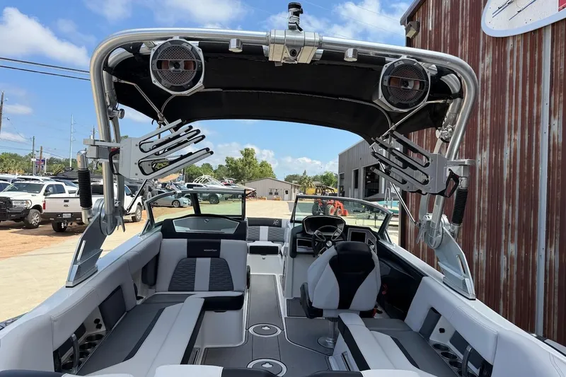 Slide: The Image of 2019 MasterCraft X22 boat interior with sleek seating and advanced audio system. - 4