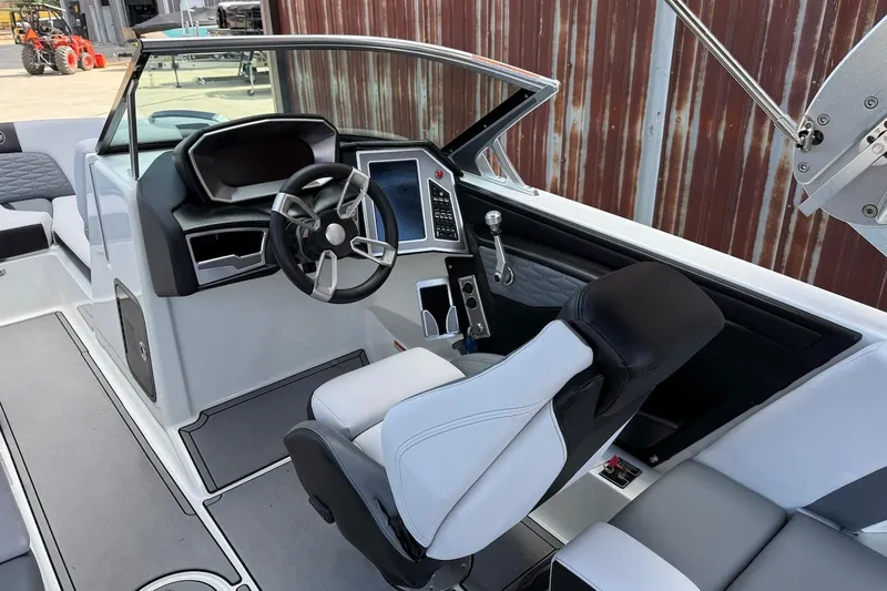 Slide: The Image of 2019 MasterCraft X22 boat interior with modern dashboard and steering wheel. - 6