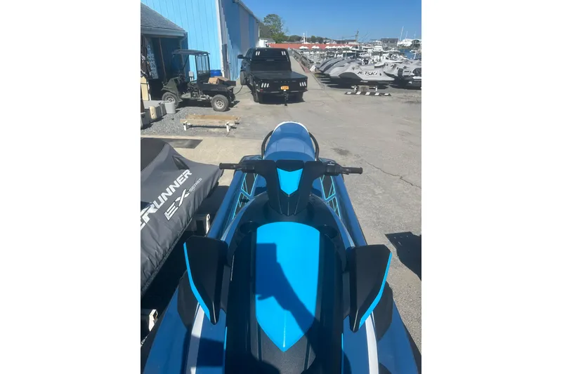 The Image of 2024 Yamaha WaveRunner FX Cruiser HO in a marina setting, showcasing sleek design and vibrant blue color. - 1