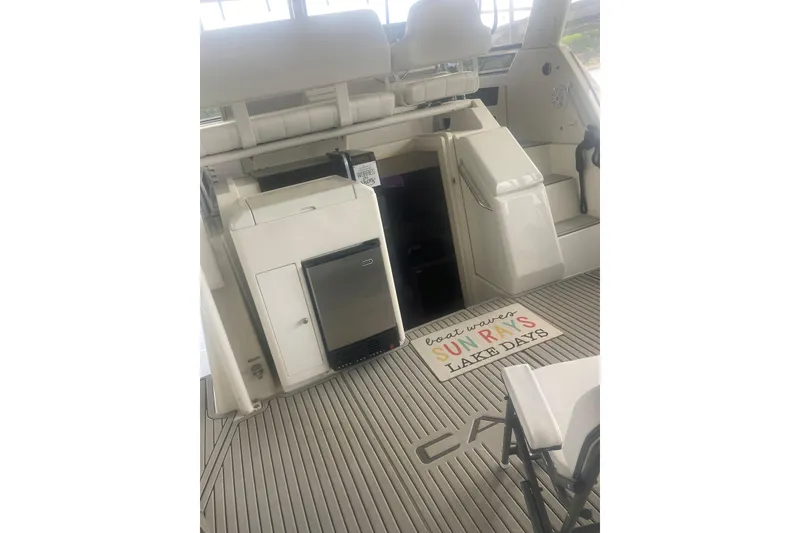 Slide: The Image of 2001 Carver 356 Motor Yacht interior with seating and mini fridge. - 4