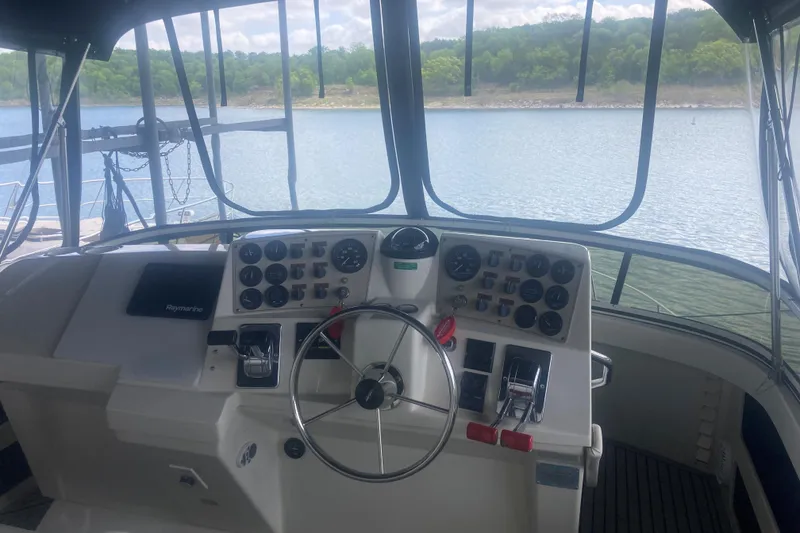 Slide: The Image of Cockpit view of 2001 Carver 356 Motor Yacht with steering wheel and control panel. - 6