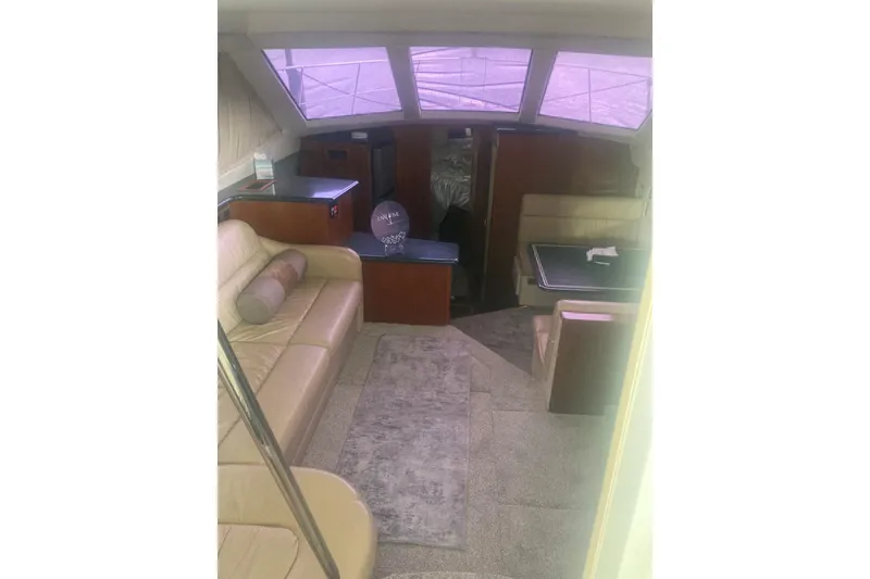 Slide: The Image of Interior of 2001 Carver 356 Motor Yacht with beige seating and dining area. - 7