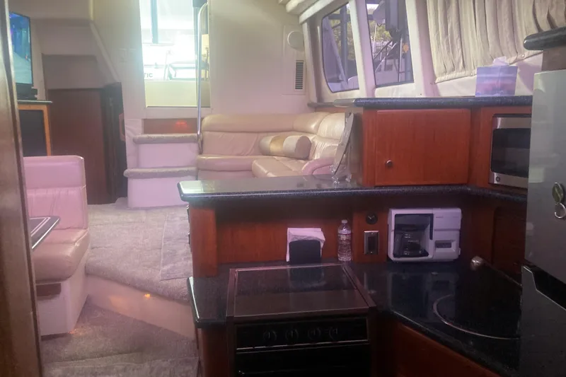 Slide: The Image of Interior of a 2001 Carver 356 Motor Yacht with kitchen and seating area. - 8
