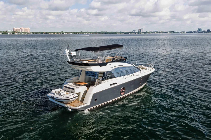 Slide: The Image of 2017 Monte Carlo Yachts MC5 cruising on open water under a cloudy sky. - 20