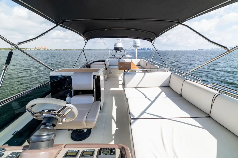 Slide: The Image of Luxurious 2017 Monte Carlo Yachts MC5 flybridge with seating, helm, and ocean view. - 42