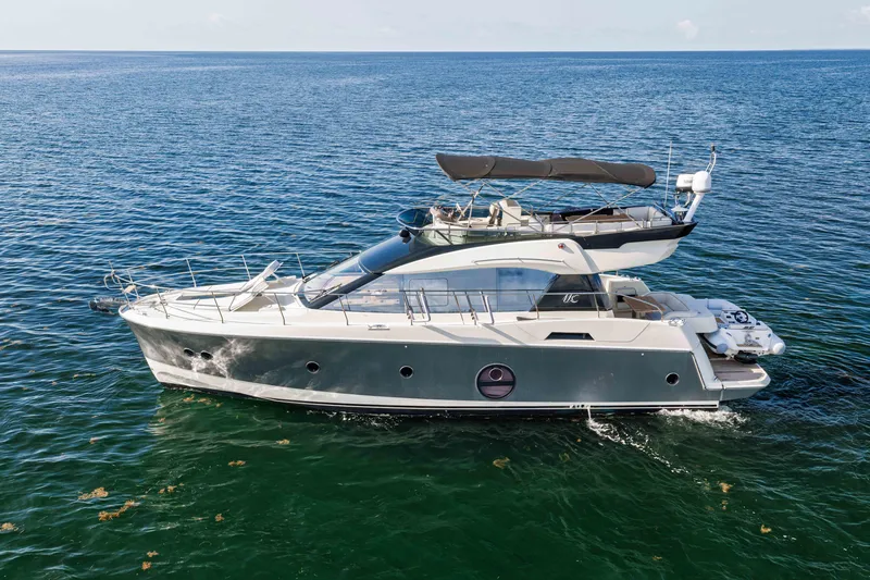 Slide: The Image of 2017 Monte Carlo Yachts MC5 cruising on open water, showcasing sleek design and luxury features. - 8
