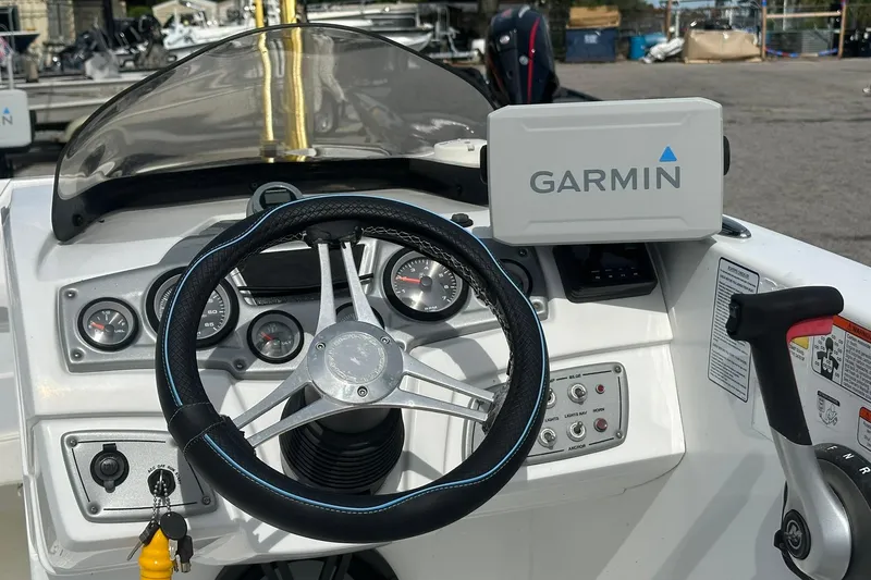 Slide: The Image of Steering console of 2021 Tahoe 2150 boat with Garmin navigation system. - 11