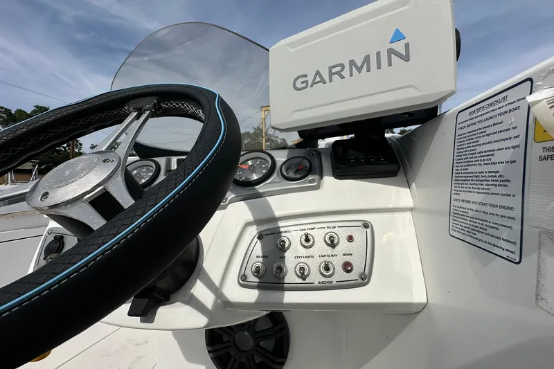 Slide: The Image of Steering wheel and dashboard of 2021 Tahoe 2150 boat with Garmin navigation system. - 13