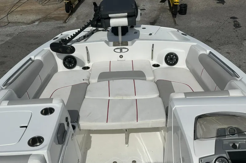 Slide: The Image of 2021 Tahoe 2150 boat interior with white and gray seating, cup holders, and speakers. - 17