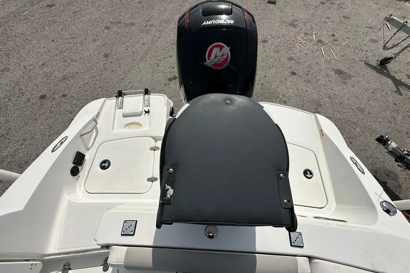 Slide: The Image of 2021 Tahoe 2150 boat with Mercury engine, featuring a spacious deck and swim platform. - 20