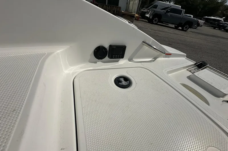 Slide: The Image of 2021 Tahoe 2150 boat deck with textured surface and control panel. - 21