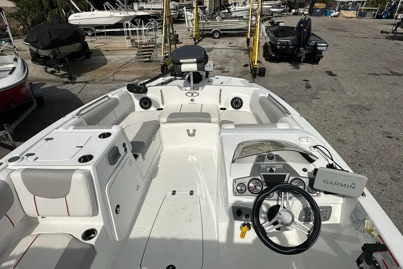 Slide: The Image of 2021 Tahoe 2150 boat interior with Garmin navigation, spacious seating, and modern dashboard. - 26