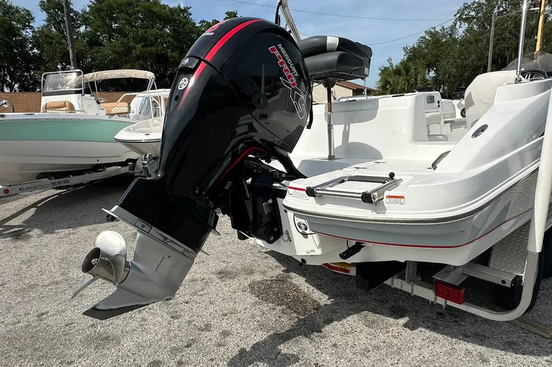 Slide: The Image of 2021 Tahoe 2150 boat with Mercury Pro XS outboard motor, parked on a trailer. - 27