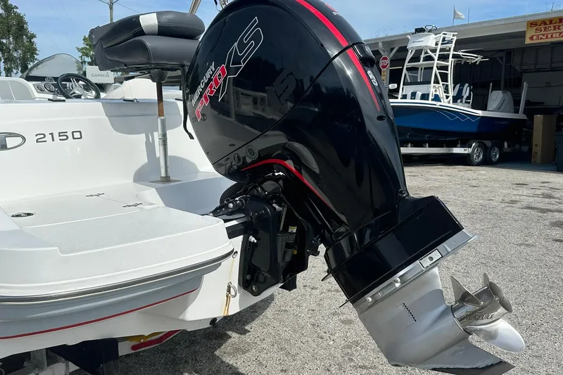 Slide: The Image of 2021 Tahoe 2150 boat with Mercury Pro XS outboard motor in a marina setting. - 28