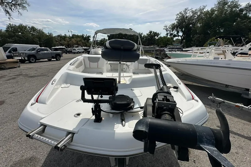 Slide: The Image of 2021 Tahoe 2150 boat with seating and equipment, parked in a marina. - 4