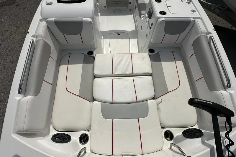 Slide: The Image of Interior of a 2021 Tahoe 2150 boat with white seating and red accents. - 7