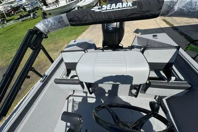 Slide: The Image of 2026 SeaArk Bay Runner 210 boat interior with steering wheel and seating. - 11