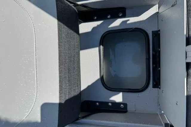 Slide: The Image of 2026 SeaArk Bay Runner 210 boat storage compartment with seating and durable construction. - 12